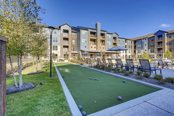 Courtyard at Alders Magnolia Apartments featuring landscaped gardens and seating areas