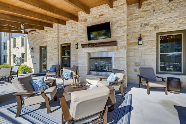 Patio at Alders Magnolia Apartments: Modern outdoor lounge with comfortable seating and lush greenery in a luxury community