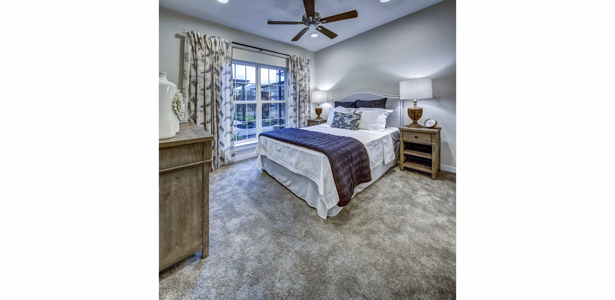 Bedroom with modern decor and large windows at NorthStar Georgetown Apartments