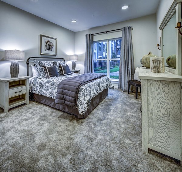 Queen-sized bed with elegant bedding in a contemporary bedroom at NorthStar Georgetown Apartments, offering luxury living near downtown activities
