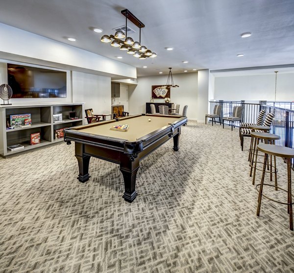 Clubhouse game room featuring pool table and modern seating at NorthStar Georgetown Apartments