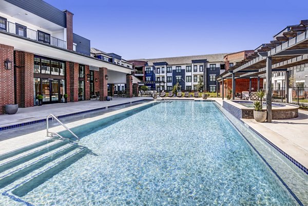 Serene pool area surrounded by lush landscape at NorthStar Georgetown Apartments, offering luxury living and relaxation opportunities
