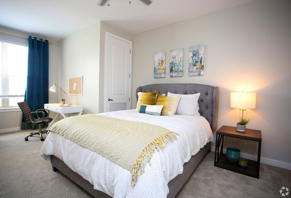 Cozy bedroom with elegant decor in The Orchards at Arlington Highlands Apartments
