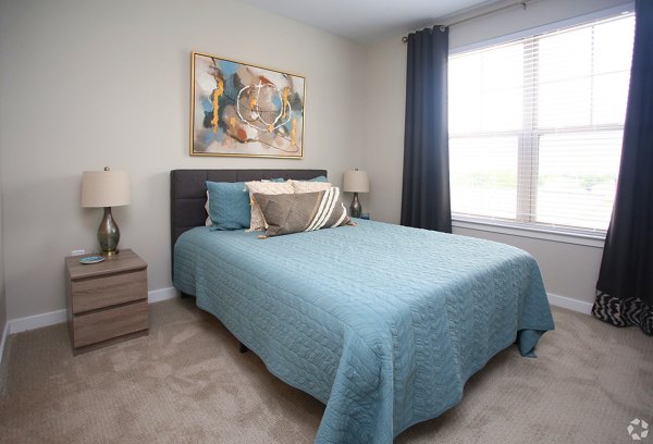 Cozy bedroom with modern decor at The Orchards at Arlington Highlands Apartments