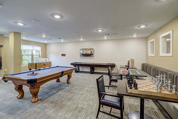 Game room with pool table and modern decor at The Orchards at Arlington Highlands Apartments