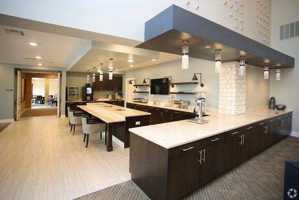 Clubhouse featuring modern furnishings and entertainment spaces at The Orchards at Arlington Highlands Apartments