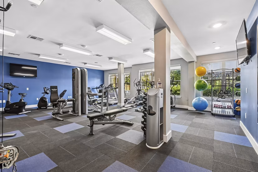 Modern fitness center with state-of-the-art equipment at The Orchards at Arlington Highlands Apartments
