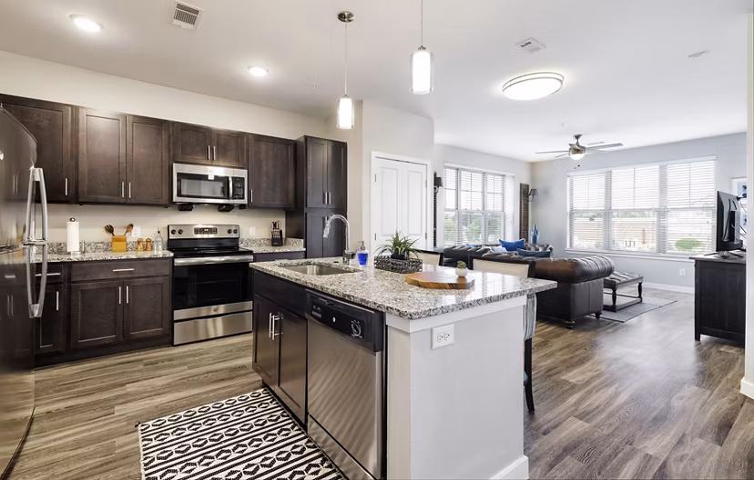 Modern kitchen with stainless steel appliances at The Orchards at Arlington Highlands Apartments