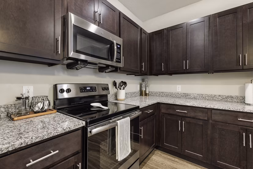 Modern kitchen with stainless steel appliances at The Orchards at Arlington Highlands Apartments