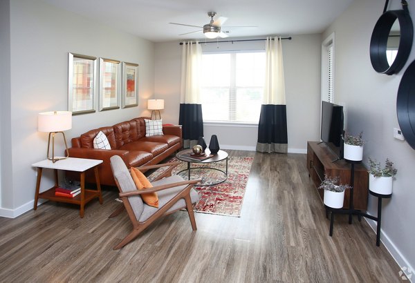 Inviting living room with cozy seating and modern decor in The Orchards at Arlington Highlands Apartments