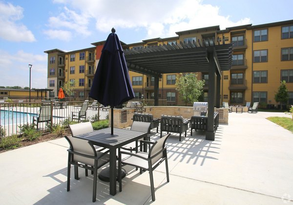 Grill area with modern seating at The Orchards at Arlington Highlands Apartments