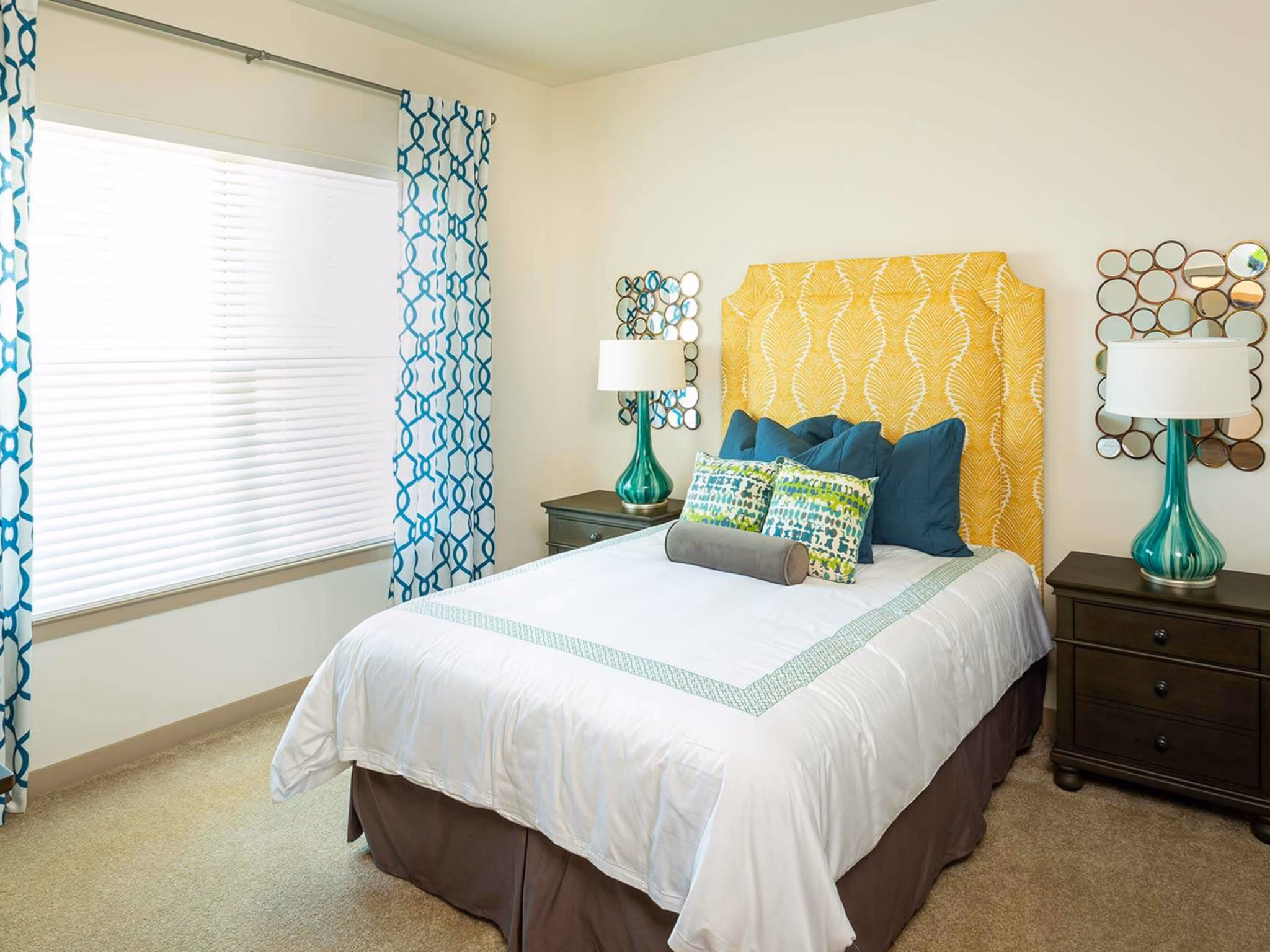 Bedroom with cozy decor and ample natural light at The Orchards at Market Plaza Apartments