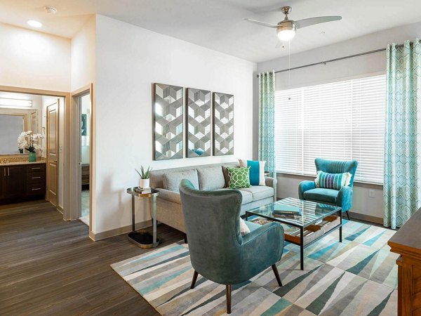 Spacious living room with modern decor in The Orchards at Market Plaza Apartments