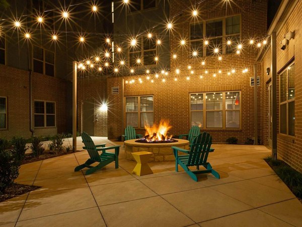 Cozy fire pit area at The Orchards at Market Plaza Apartments, perfect for social gatherings and outdoor relaxation