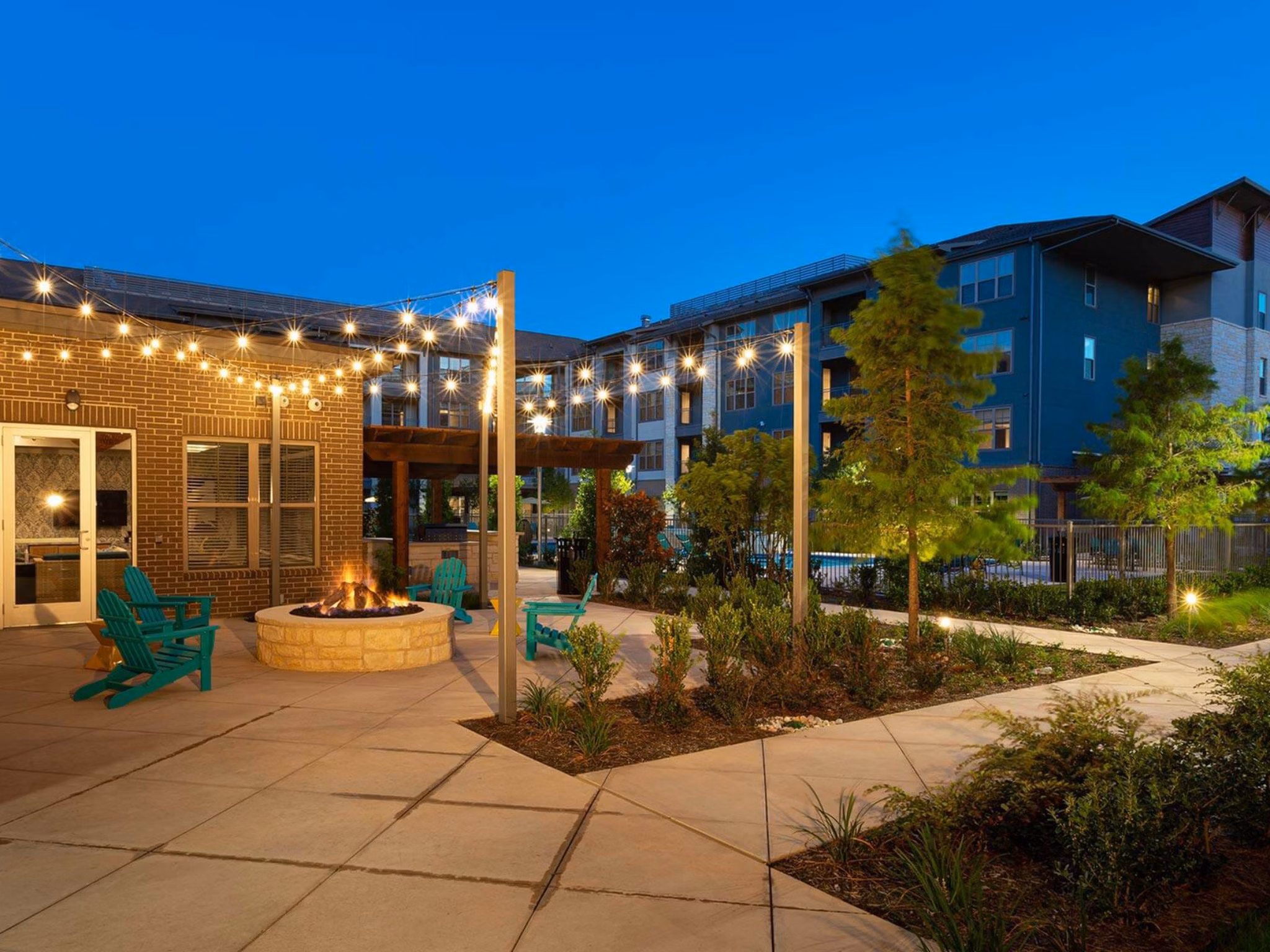 Courtyard with lush gardens and seating areas at The Orchards at Market Plaza Apartments