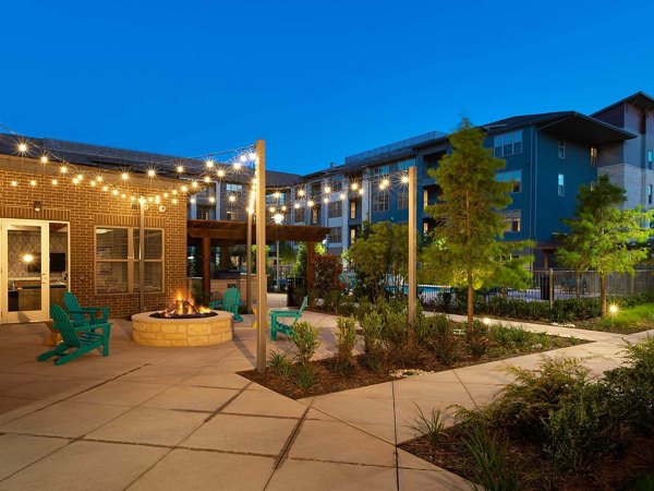 Courtyard with lush gardens and seating areas at The Orchards at Market Plaza Apartments