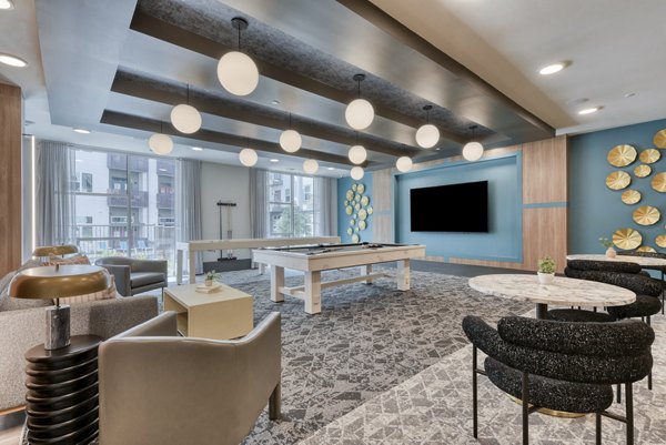 Clubhouse featuring luxurious seating and entertainment options at Encore Grayson Apartments, ideal for social gatherings and community events