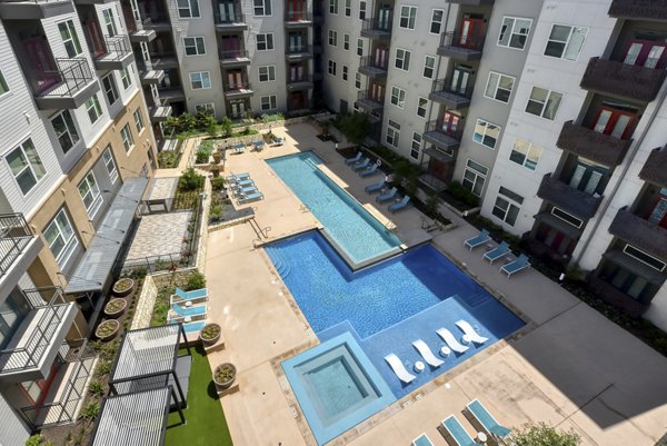 Luxurious pool at Encore Grayson Apartments offering a resort-style escape with lounge chairs and serene surroundings