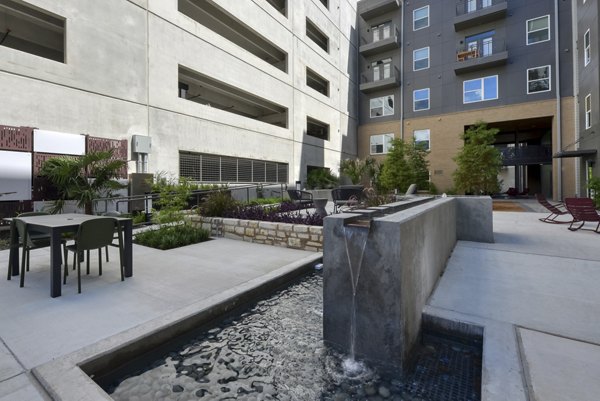 Courtyard with landscaped gardens and seating at Encore Grayson Apartments