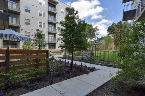 Courtyard featuring lush greenery and modern seating at Encore Grayson Apartments
