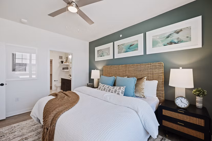 Cozy bedroom with chic decor and large windows at Silos Harvest Green Apartments