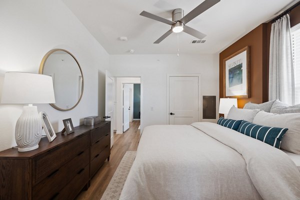 Spacious bedroom with modern furnishings at Silos Harvest Green Apartments in Houston