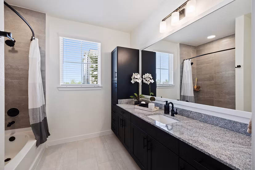 Luxurious bathroom featuring modern fixtures and elegant design in Silos Harvest Green Apartments