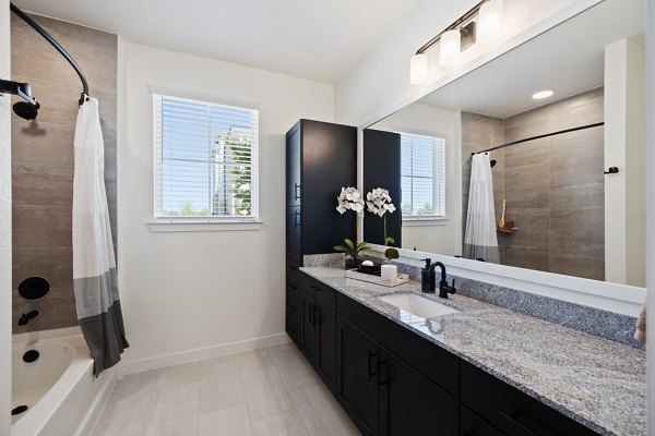 Luxurious bathroom featuring modern fixtures and elegant design in Silos Harvest Green Apartments