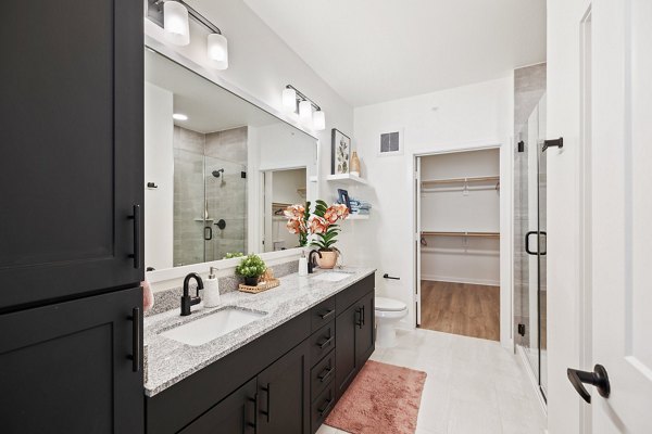 Luxurious bathroom with marble countertops and contemporary fixtures at Silos Harvest Green Apartments