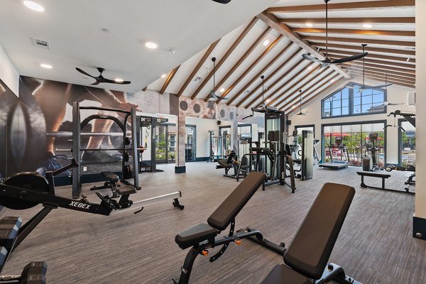 Well-equipped fitness center at Silos Harvest Green Apartments, featuring modern machines and weights ideal for active residents