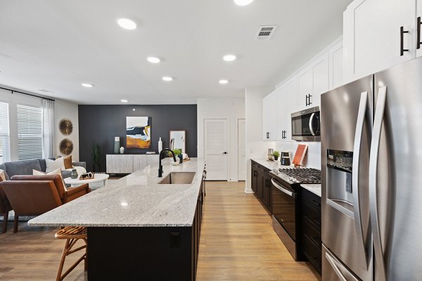Modern kitchen with stainless steel appliances at Silos Harvest Green Apartments, offering luxury living and top-tier amenities