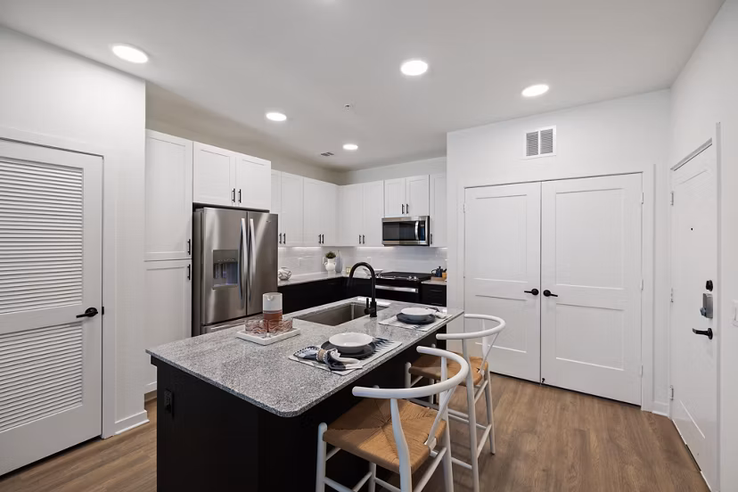 Modern kitchen with sleek countertops and stainless steel appliances at Silos Harvest Green Apartments