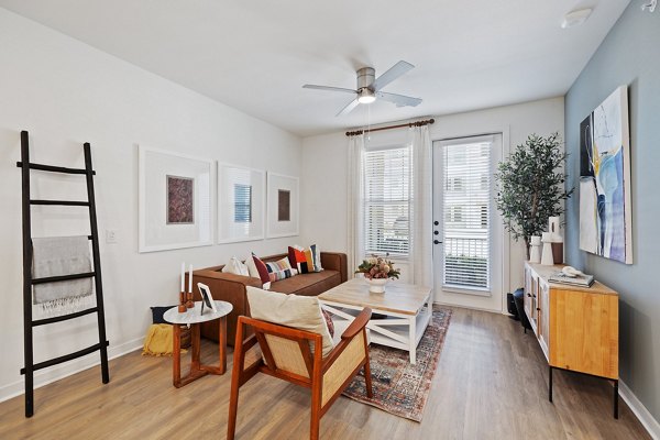 Spacious living room with modern decor at Silos Harvest Green Apartments