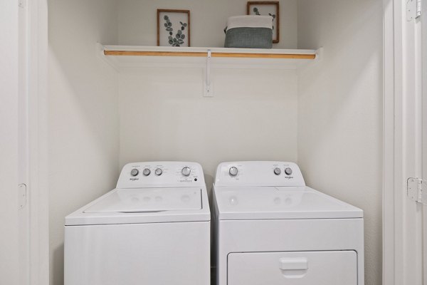 Laundry room featuring modern washers and dryers at Silos Harvest Green Apartments