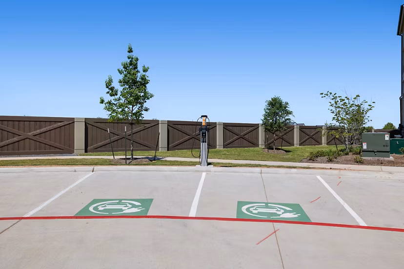 Car charging station at Silos Harvest Green Apartments offering sustainable living options for eco-conscious residents