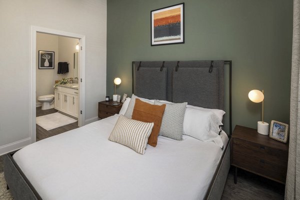 Elegant bedroom with cozy furnishings at Prose McCullough Station Apartments