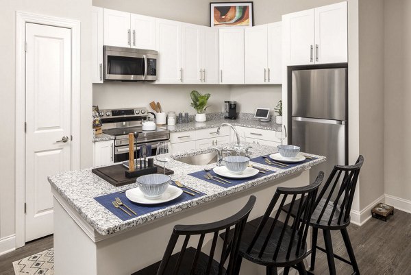 Modern kitchen with stainless steel appliances at Prose McCullough Station Apartments