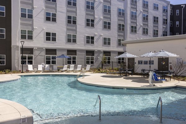 Resort-style pool with lounging areas at Prose McCullough Station Apartments