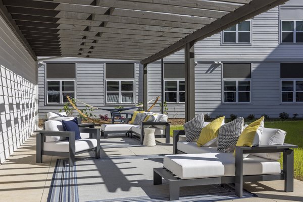 Cozy patio with modern furnishings at Prose McCullough Station Apartments, ideal for outdoor relaxation and gatherings in style