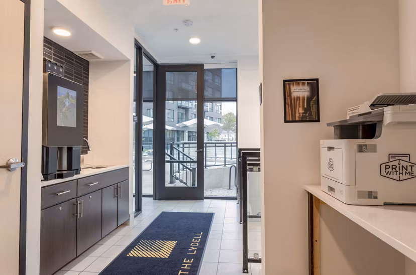 Modern business center with sleek workstations at The Lydell Apartments, offering residents a dedicated space for productivity and work