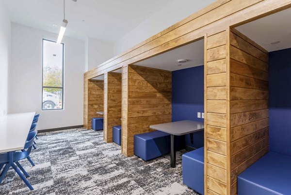 Clubhouse with modern decor and seating areas at The Lydell Apartments, ideal for social gatherings and community events