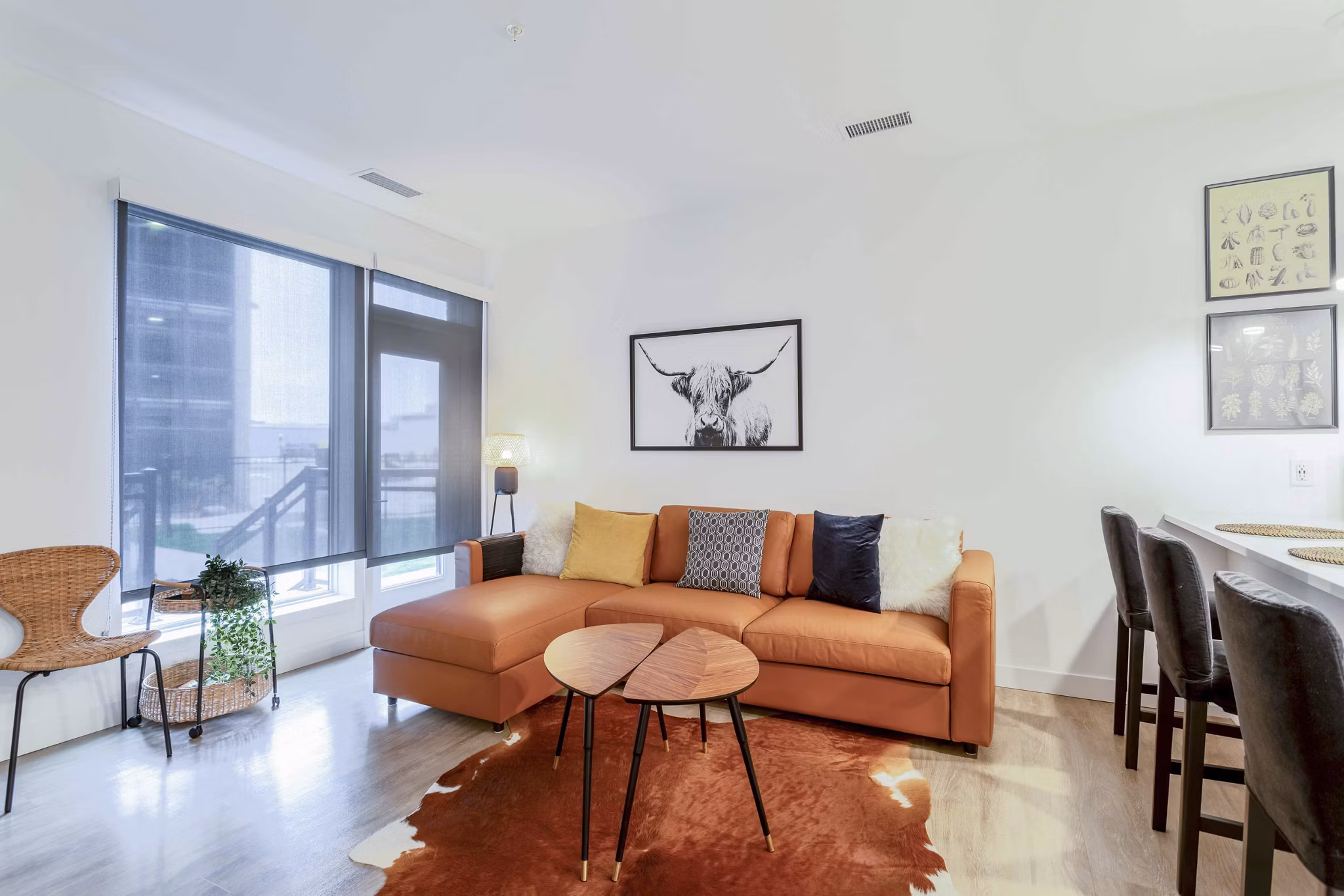 Cozy living room with plush seating and large windows at The Lydell Apartments