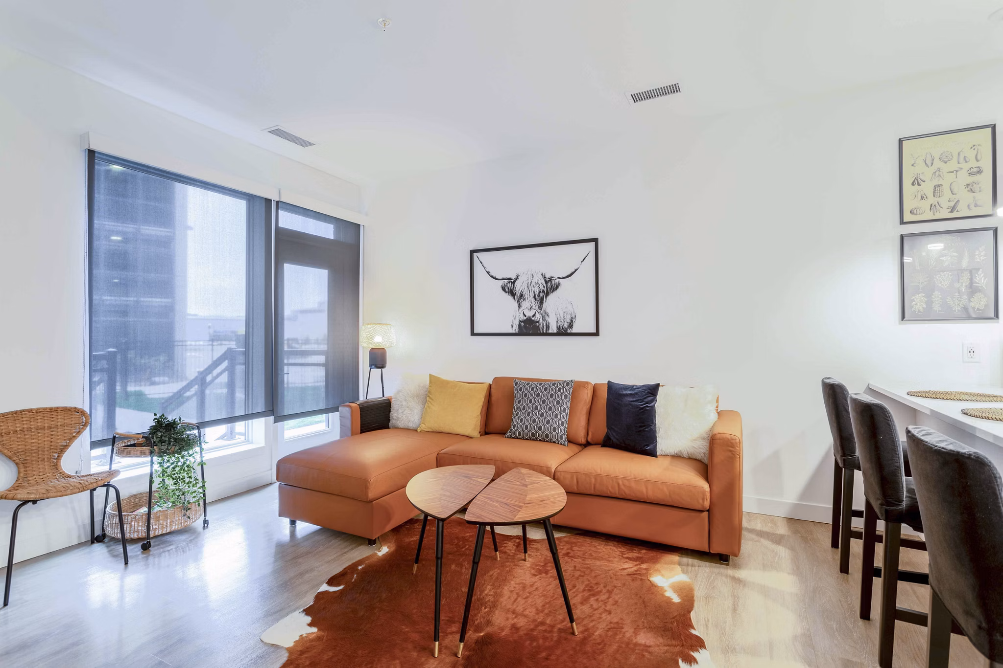 Cozy living room with plush seating and large windows at The Lydell Apartments