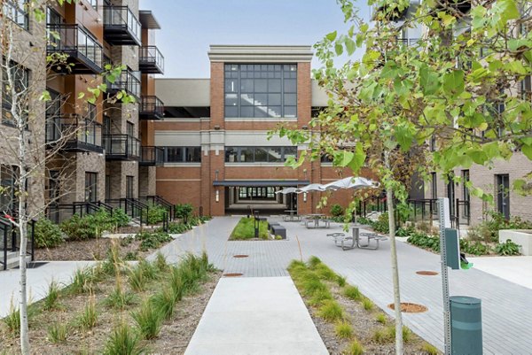 Courtyard with lush greenery and seating at The Lydell Apartments