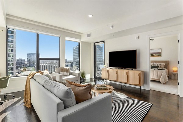Spacious living room featuring modern decor at One Seven Belleview Station Apartments