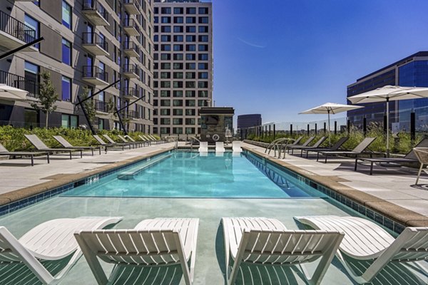 Luxurious pool area with modern lounge chairs at One Seven at Belleview Station Apartments, offering relaxation and leisure in a premium setting