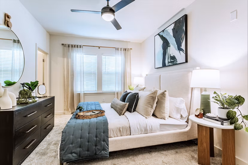 Birchway Rivergate Apartments: Cozy bedroom with elegant decor and plush bedding, offering a comfortable living space