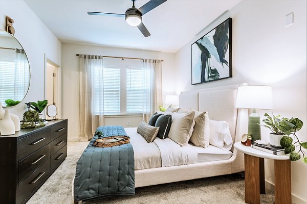 Birchway Rivergate Apartments: Cozy bedroom with elegant decor and plush bedding, offering a comfortable living space