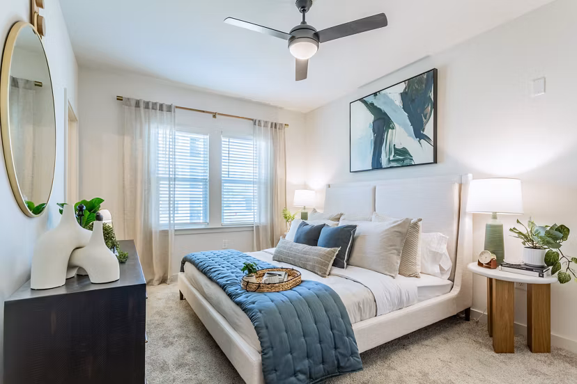 Cozy bedroom with modern furnishings at Birchway Rivergate Apartments