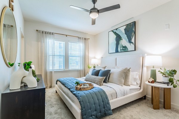 Cozy bedroom with modern furnishings at Birchway Rivergate Apartments